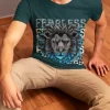 man-sitting-on-a-wooden-floor-wear-lion-face-round-neck-petrol-blue-color-tshirt