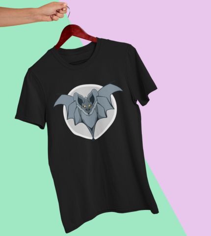 Black T-shirt with a bat graphic printed on the front, displayed on a wooden hanger against a pastel geometric background.