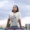 Woman wearing a White Cattitude T-Shirt with a cool cat graphic and sunglasses