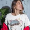 Woman wearing a White Cattitude T-Shirt with a cool cat graphic and sunglasses
